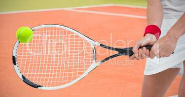 Composite image of athlete playing tennis with a racket