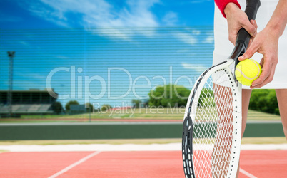 Composite image of athlete holding a tennis racquet ready to ser