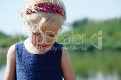 Cute little blonde girl with hair band, close-up