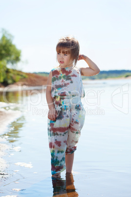 Little girl posing in fashionable overall