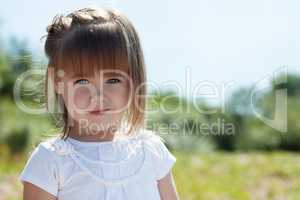 Portrait of lovely little girl in park