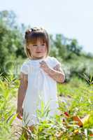 Curious little model posing in park