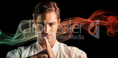 Composite image of portrait of fighter performing hand salute