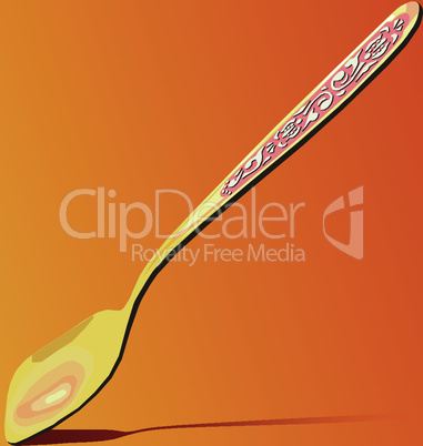 Golden teaspoon with silver ornaments cast a shadow