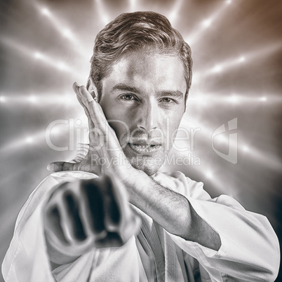 Composite image of portrait of fighter performing karate stance