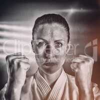 Composite image of female fighter performing karate stance