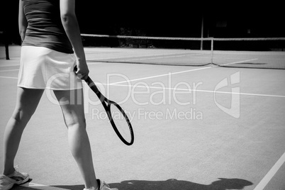 Tennis player standing on court