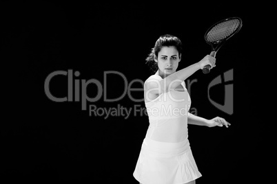 Portrait of confident female tennis player with racquet