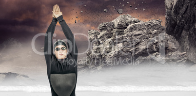 Composite image of swimmer in wetsuit while diving