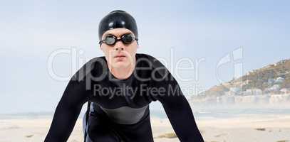 Composite image of confident swimmer in wetsuit