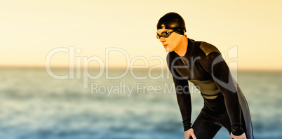 Composite image of swimmer in wetsuit and swimming goggles