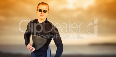 Composite image of swimmer in wetsuit and swimming goggles