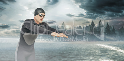 Composite image of swimmer in wetsuit while diving