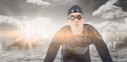 Composite image of confident swimmer in wetsuit