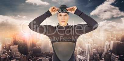 Composite image of swimmer in wetsuit wearing swimming goggles