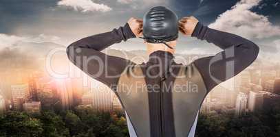 Composite image of rear view of swimmer in wetsuit wearing swimm