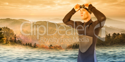 Composite image of swimmer in wetsuit wearing swimming goggles