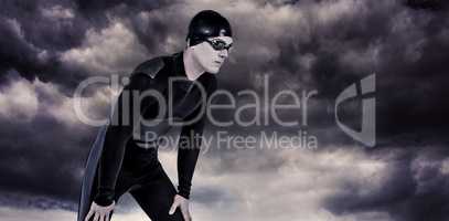 Composite image of swimmer in wetsuit and swimming goggles