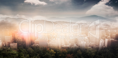 Composite image of trees and mountain range against cloudy sky