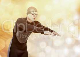 Composite image of swimmer in wetsuit while diving