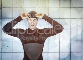 Composite image of swimmer in wetsuit wearing swimming goggles