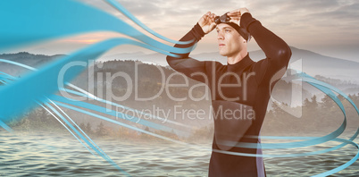 Composite image of swimmer in wetsuit wearing swimming goggles