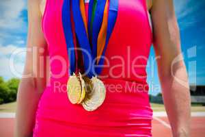 Composite image of portrait of sportswoman chest with medals