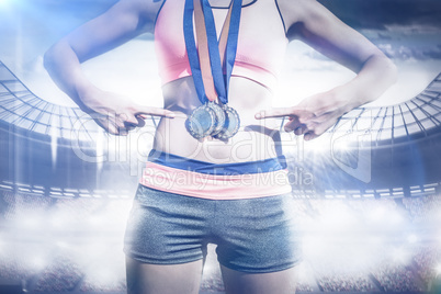 Composite image of close up of sportswoman chest with medals