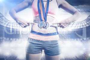 Composite image of close up of sportswoman chest with medals