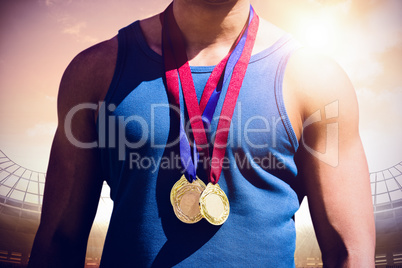 Composite image of portrait of sportsman chest with medals