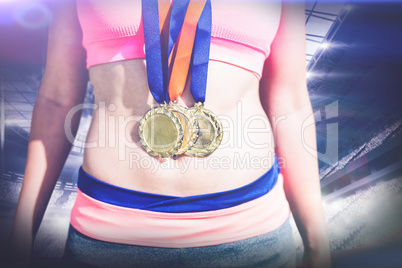 Composite image of close up of sportswoman chest with medals