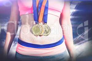 Composite image of close up of sportswoman chest with medals