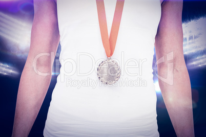 Composite image of female athlete wearing a medal