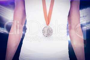 Composite image of female athlete wearing a medal