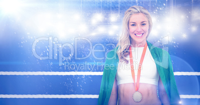 Composite image of athlete posing with gold medal after victory