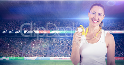 Composite image of female athlete posing with gold medals after