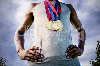 Composite image of low angle view of sportsman chest with medals
