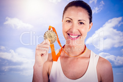 Composite image of female athlete posing with gold medals after