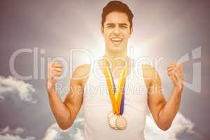 Composite image of athlete posing with gold medal after victory