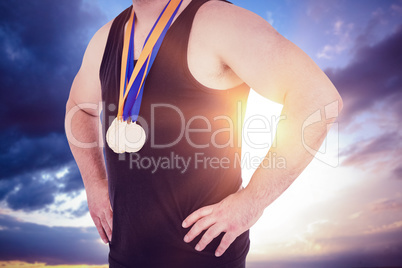 Composite image of close-up of athlete with olympic medal