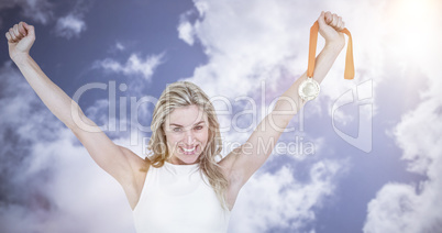 Composite image of athlete posing with gold medal after victory