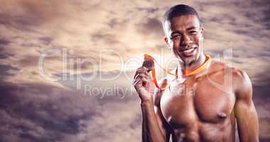 Composite image of fighter holding gold medal