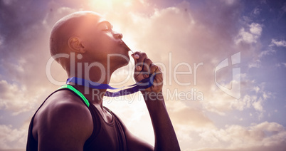 Composite image of profile view of athletic man kissing his gold