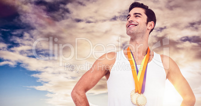 Composite image of athlete posing with gold medals around his ne