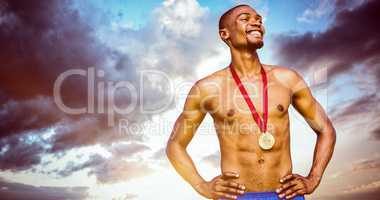 Composite image of athletic man posing with his gold medal