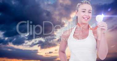 Composite image of happy female athlete holding medal