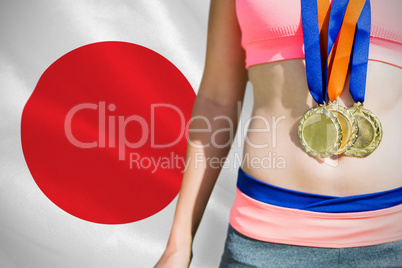 Composite image of close up of sportswoman chest with medals Composite image of close up of sportswoman chest with medals