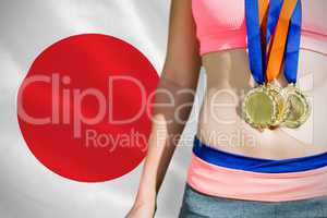 Composite image of close up of sportswoman chest with medals