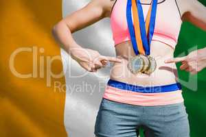 Composite image of close up of sportswoman chest with medals