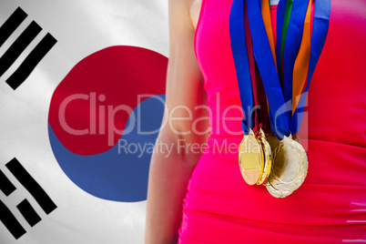 Composite image of portrait of sportswoman chest with medals